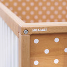 A close up shot of the corner of a cot