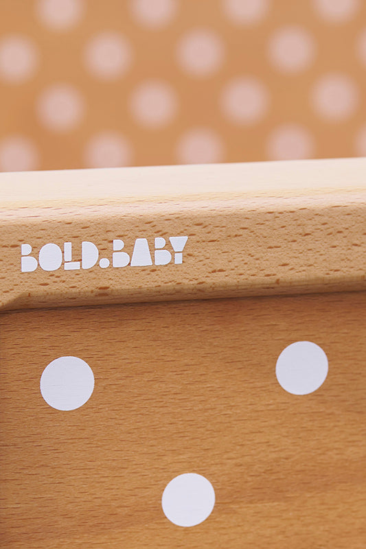 Bold Baby logo on the end of a cot