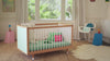 A woman transforms the look of a beautiful customisable, designer cot